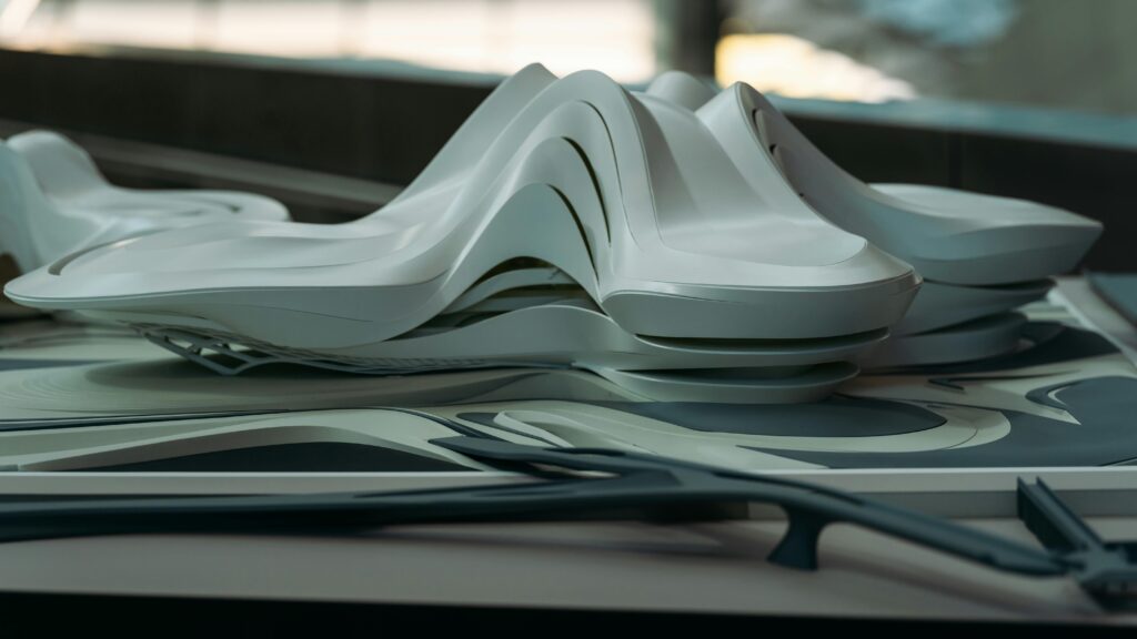A modern architectural model with sleek curves, showcasing futuristic design elements.